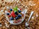 A top view of a healthy granola breakfast with fresh berries and yogurt in București.