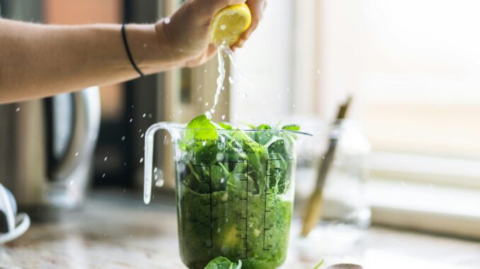 person squeezing lemon